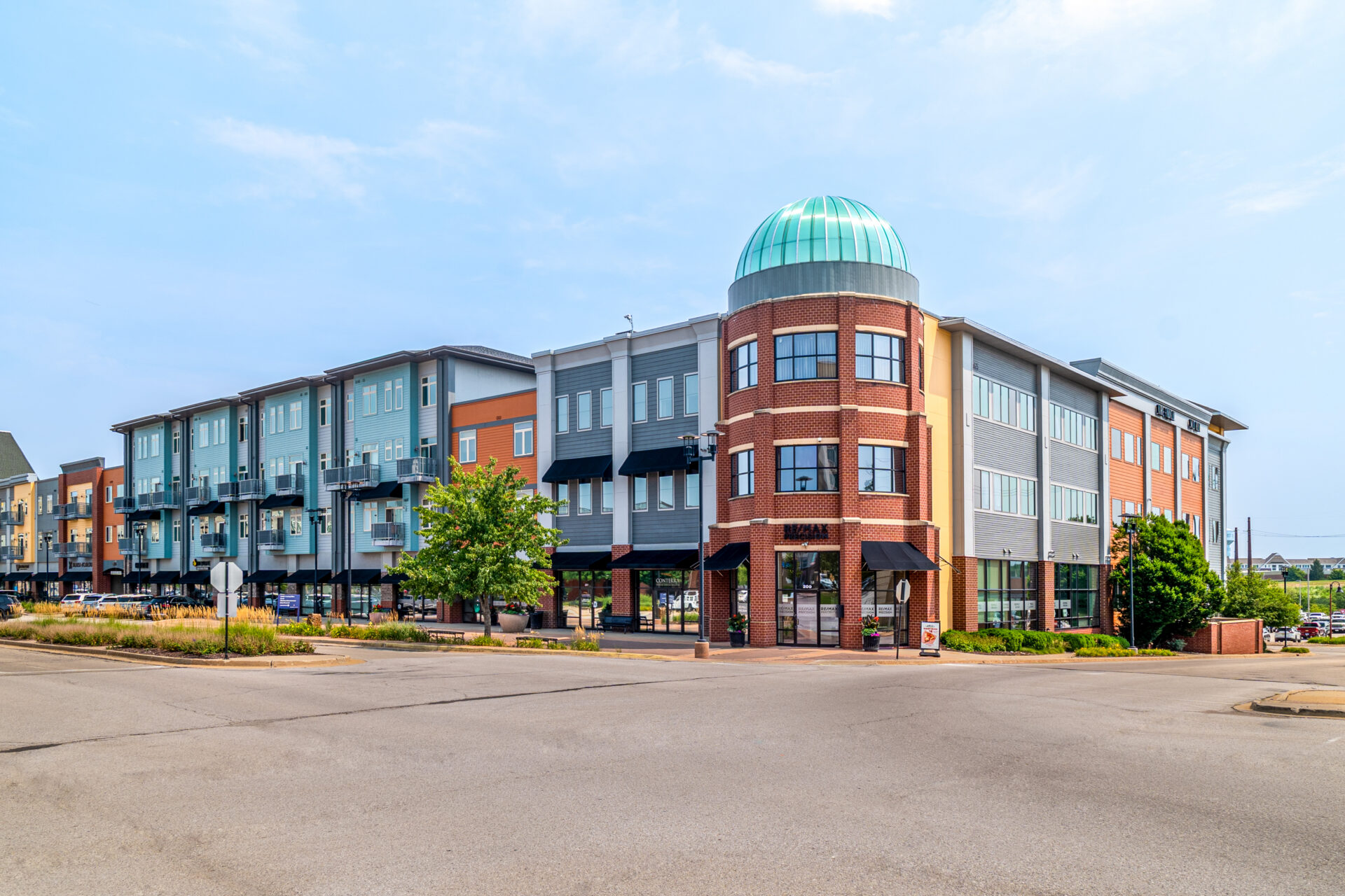 Mixed-use buildings at West Glen Town Center in West Des Moines, Iowa, featuring ground-floor retail space and upper-level residential units
