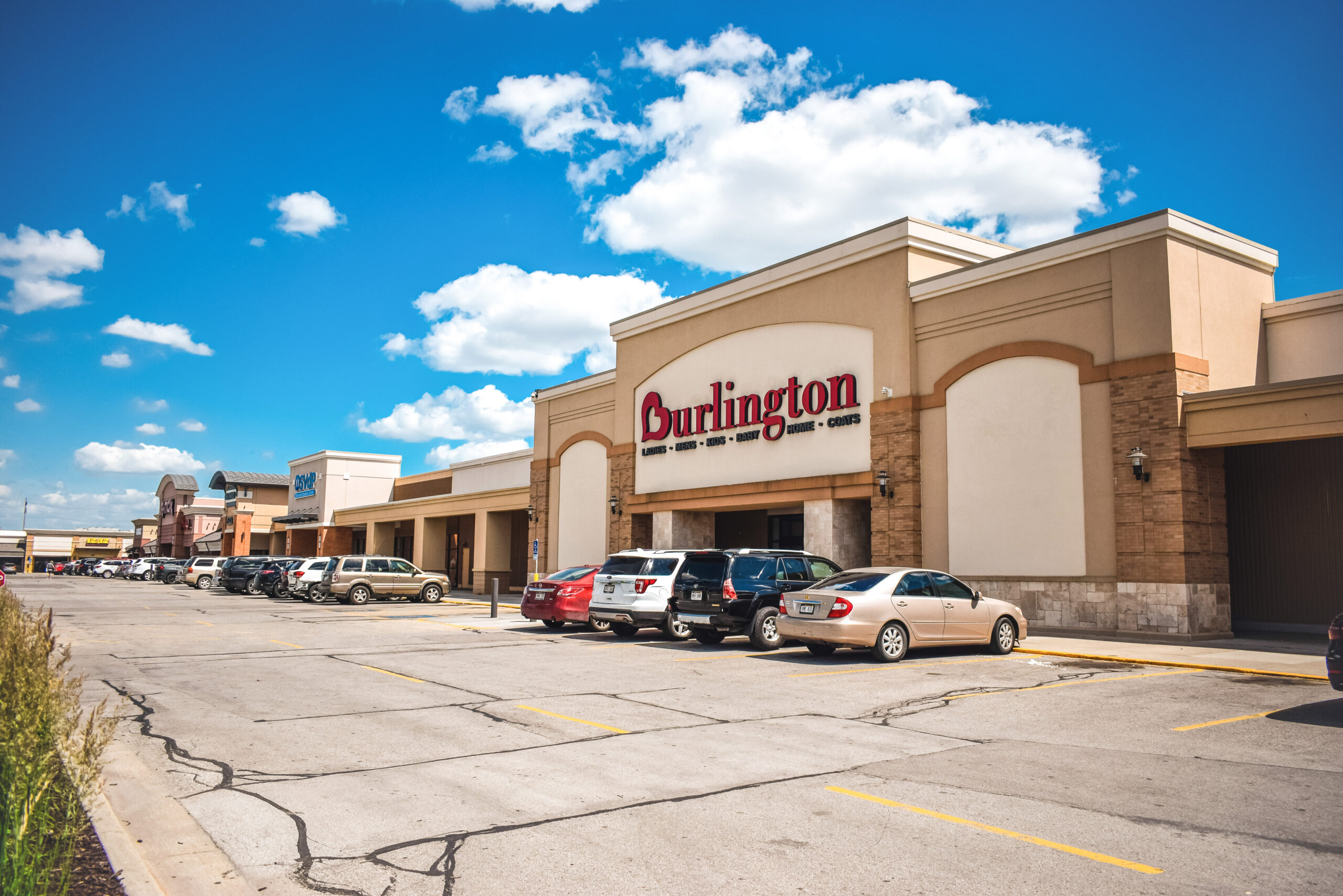 TJ Maxx at 12285 W Center Road, Omaha, NE 68144, in Westwood Plaza, featuring a prominent retail storefront, ample front-door parking, and neighboring shopping center tenants in West Omaha